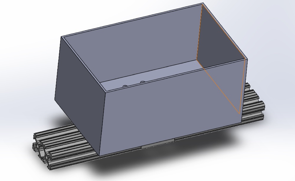 CAD model of the sensor box enclosure resting on a length of T-slotted aluminum rail